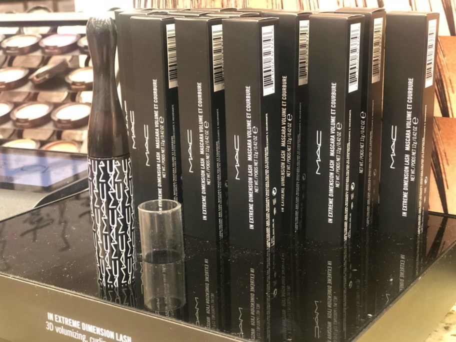 display with mascara in boxes on store shelf