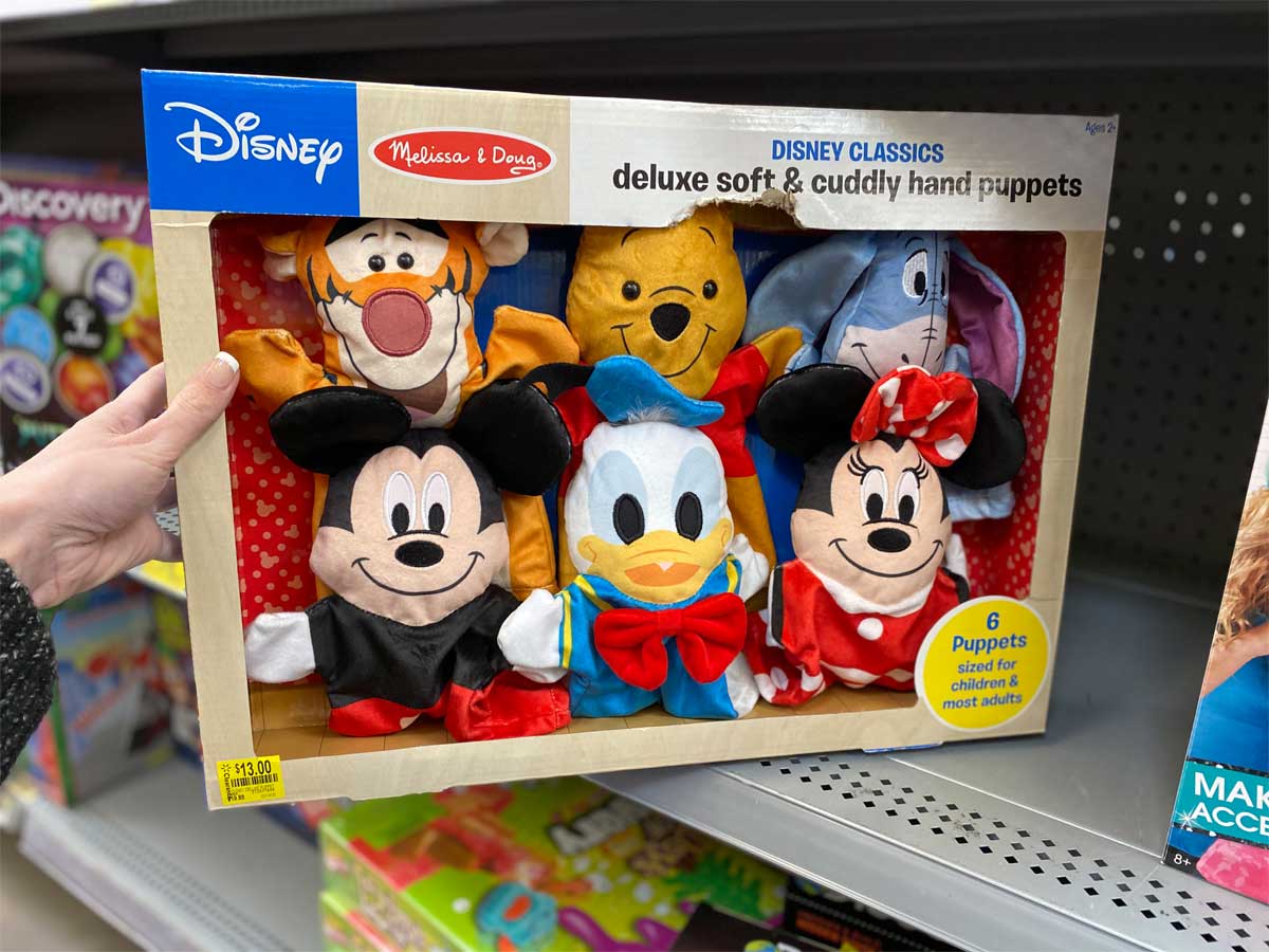 hand holding Melissa & Doug Disney Classics Deluxe Soft & Cuddly Hand Puppets, Set of 6