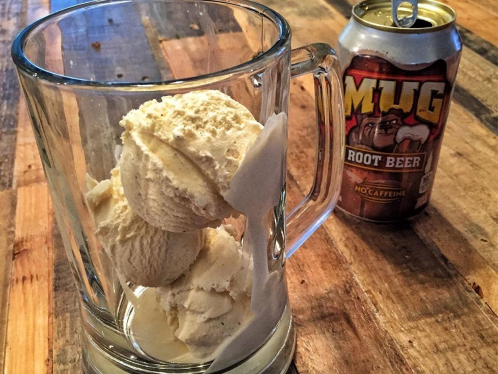 mug root beer can with class of ice cream next to can