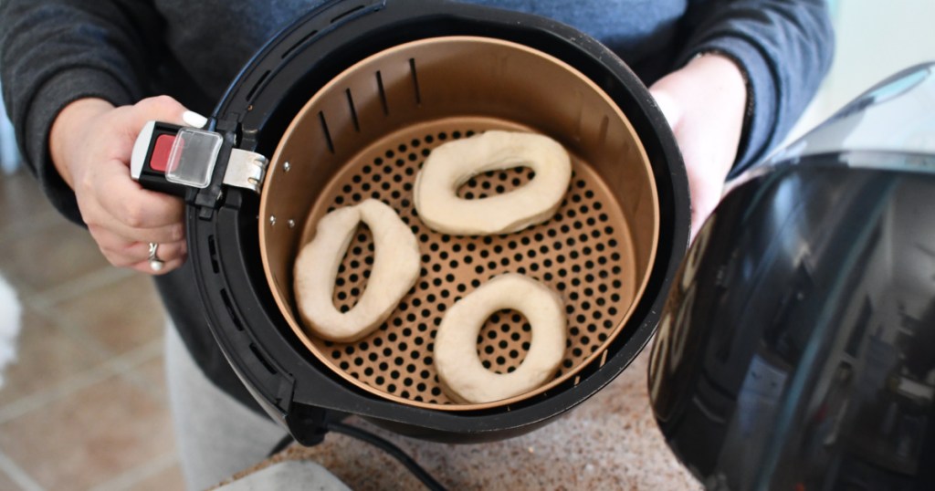 placing biscuit donuts in an air fryer