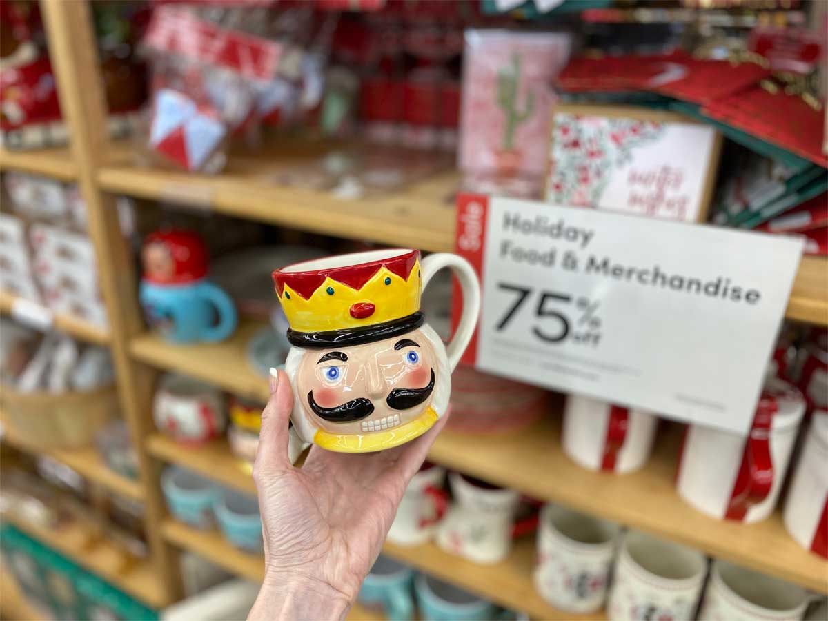 woman hand holding a nutcracker coffee mug