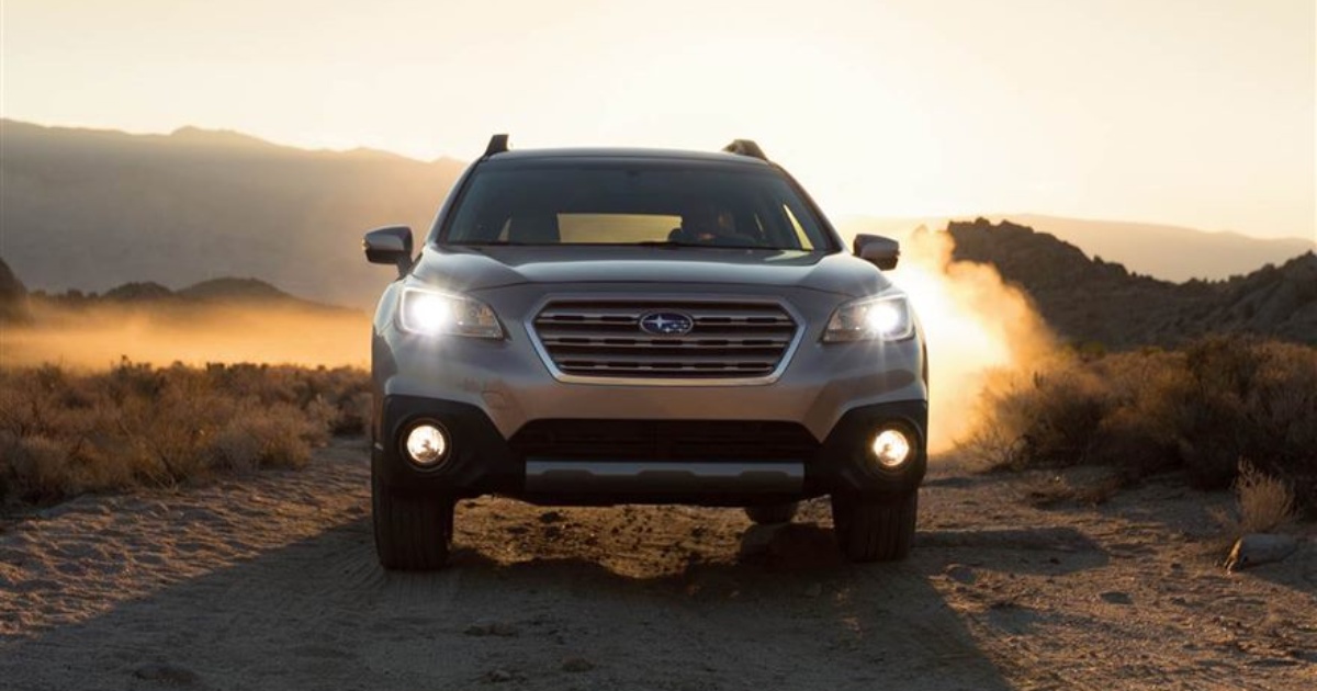 Subaru in desert with lights on