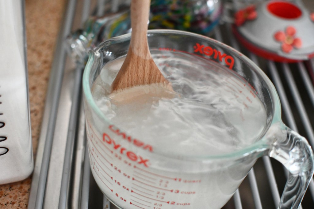 stirring sugar and water for hummingbird food recipe