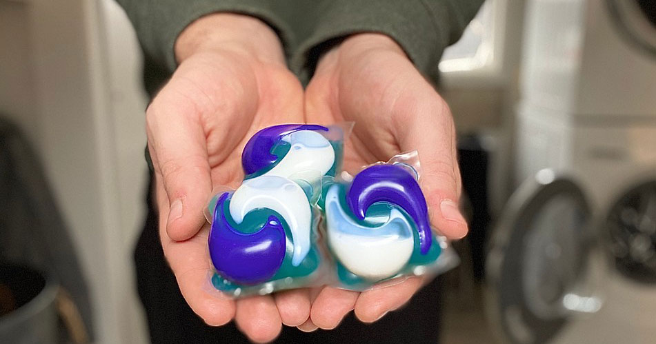 Hands holding Tide PODS