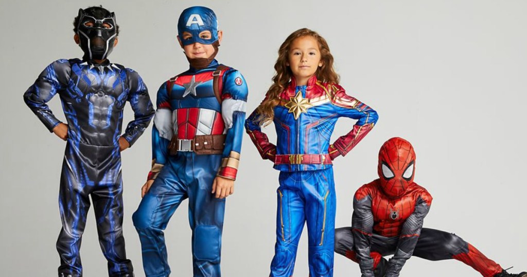 kids standing in Halloween Avengers costumes