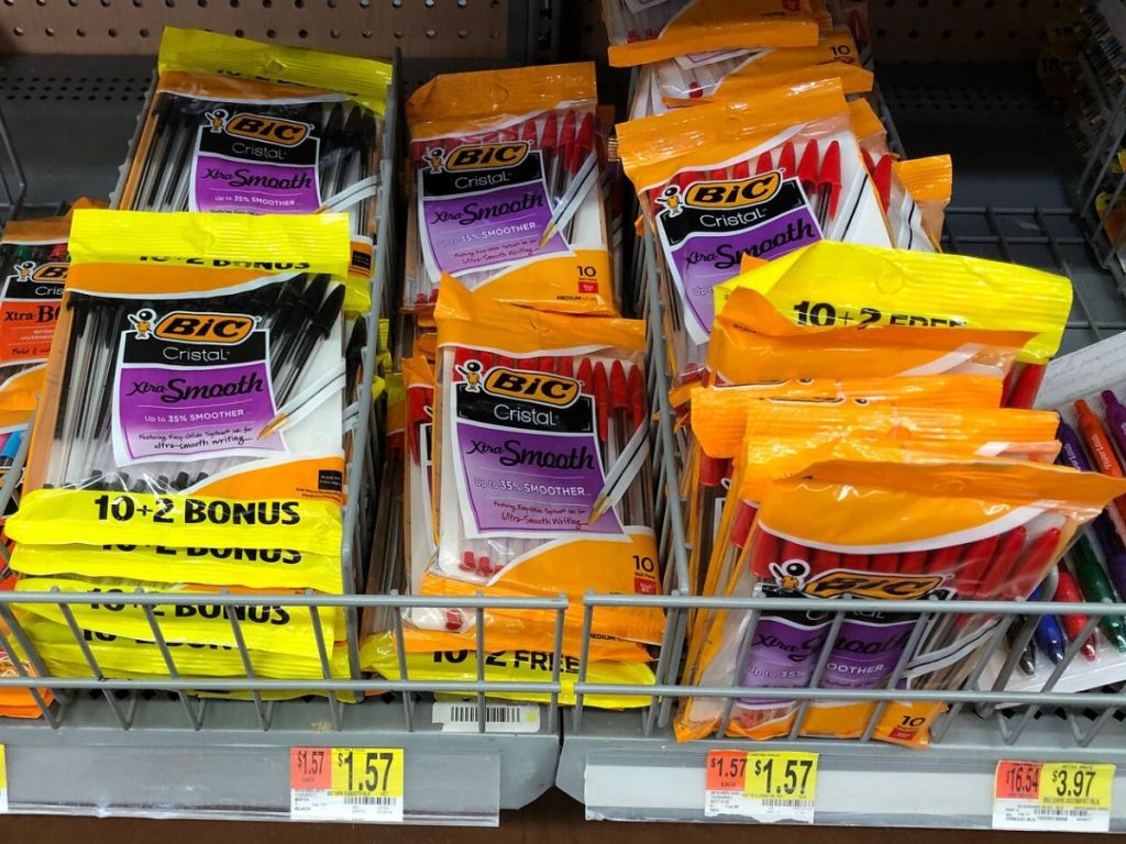 bottom shelf at store with metal baskets holding packages of pens