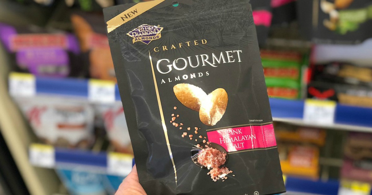 hand holding bag of blue diamond gournet almonds in pink Himalayan salt