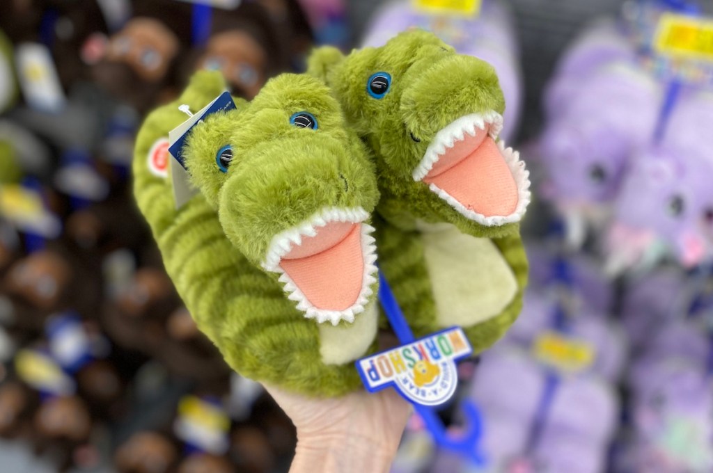 hand holding Build-A-Bear Dinosaur Slippers