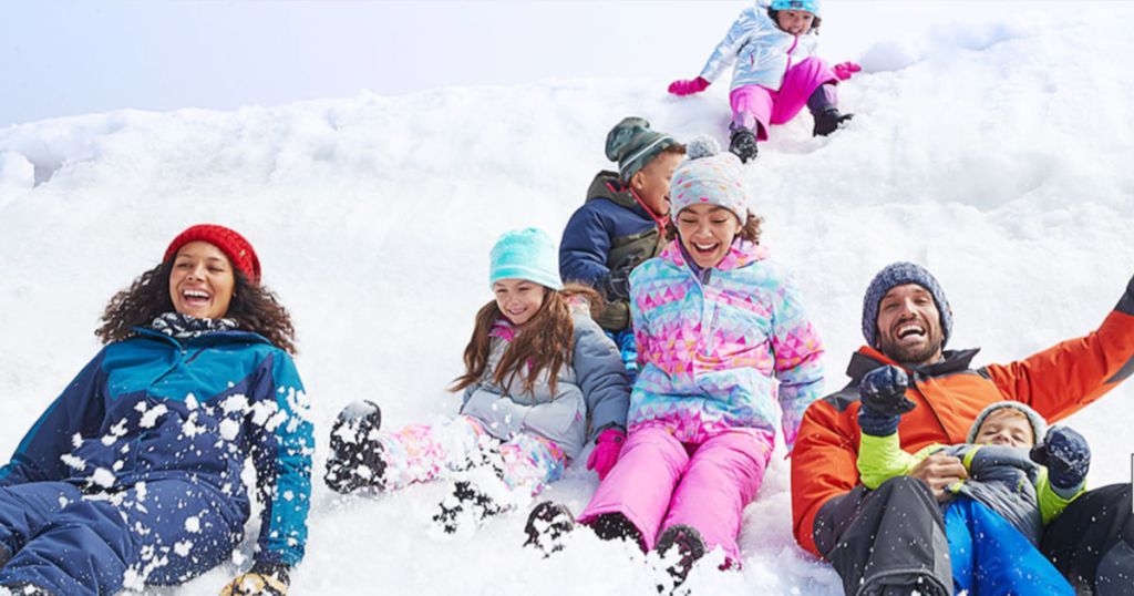 Family wearing Eddie Bauer winter gear in the snow