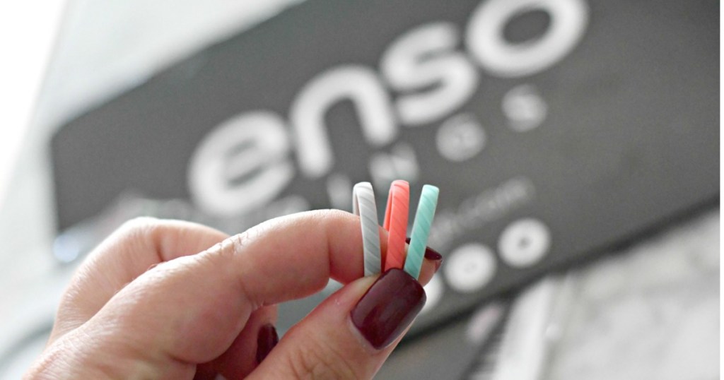 Woman holding 3 colorful silicone rings