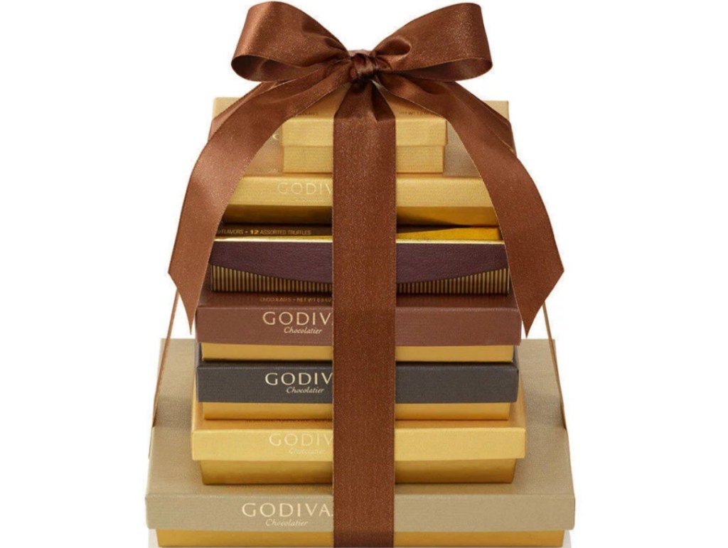 seven gold boxes stacked and tied with a ribbon