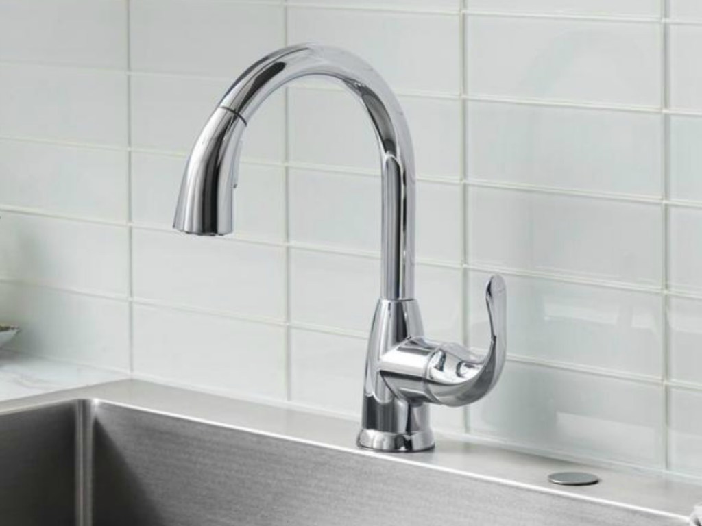 Stainless steel faucet on large porcelain sink