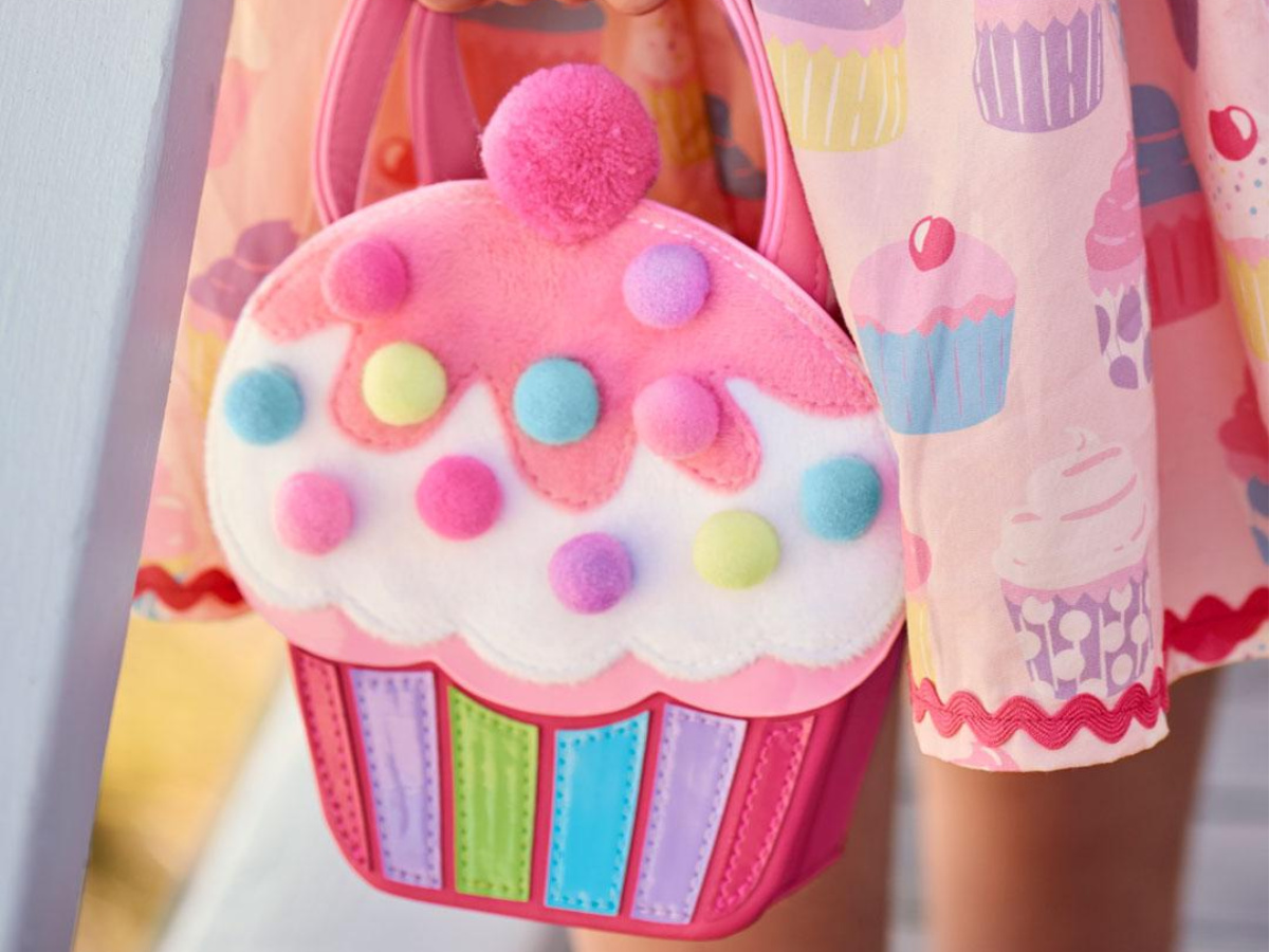 girl holding Hello Cupcake Purse wearing cupcake skirt