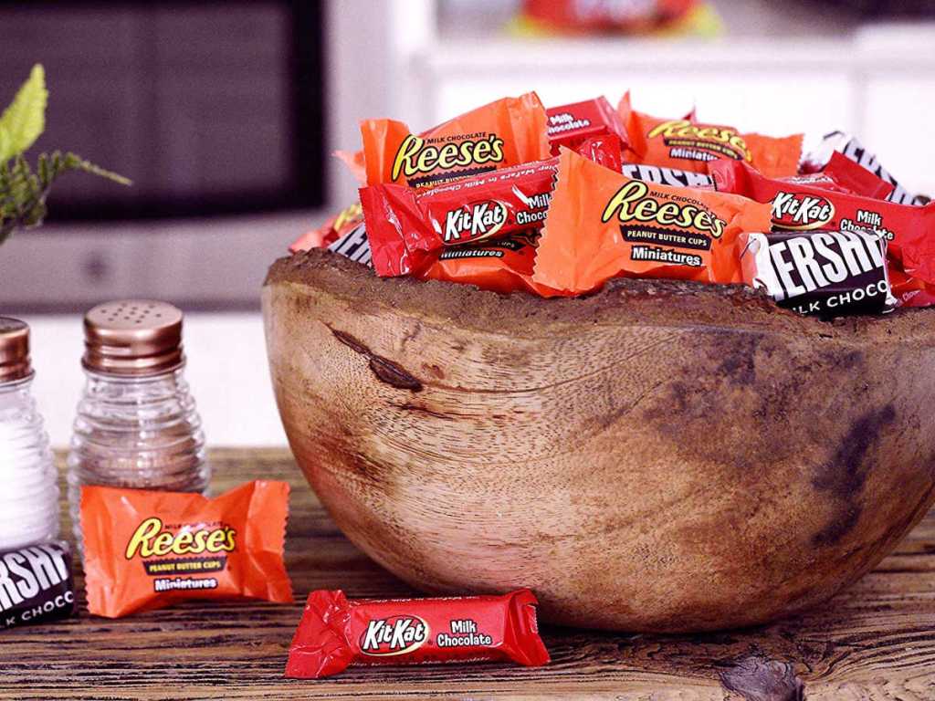 Hershey's, Kit Kat, Reese's candies in a wooden bowl