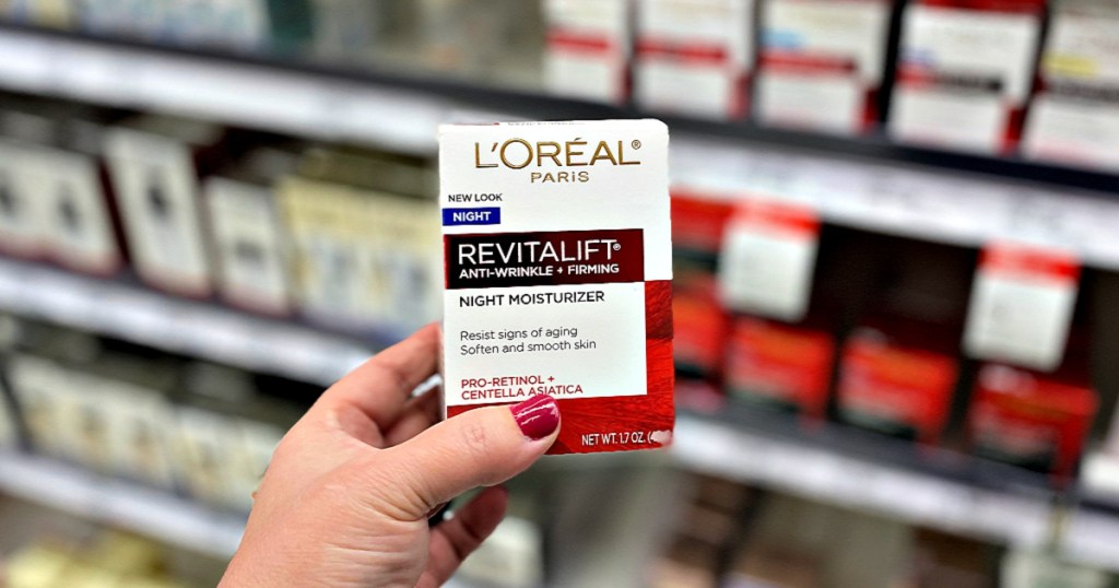 L'Oreal Revitalift Anti-Wrinkle + Firming Night Moisturizer in woman's hand in store aisle