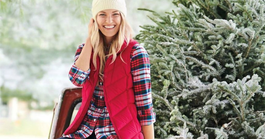 woman wearing red puffer vest and flannel