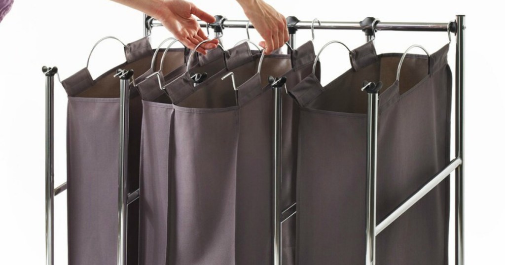 woman picking up hamper out of Neatfreak Laundry Sorter