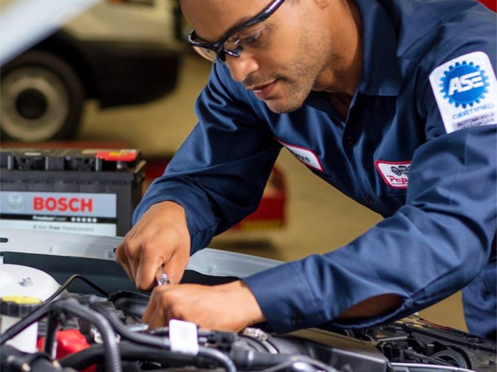 Pep Boys technician working on battery