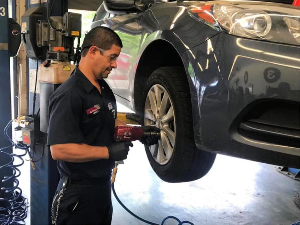 Pep Boys technician working on tires