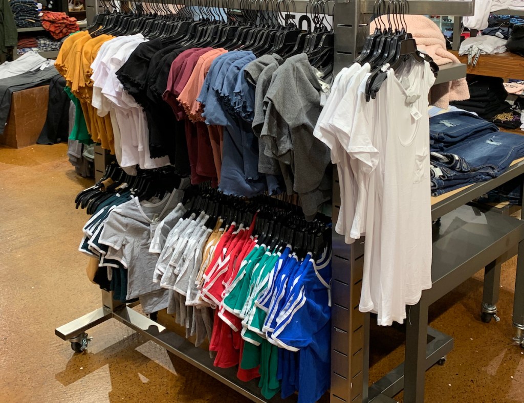 girls tees on hangers on a display at a store