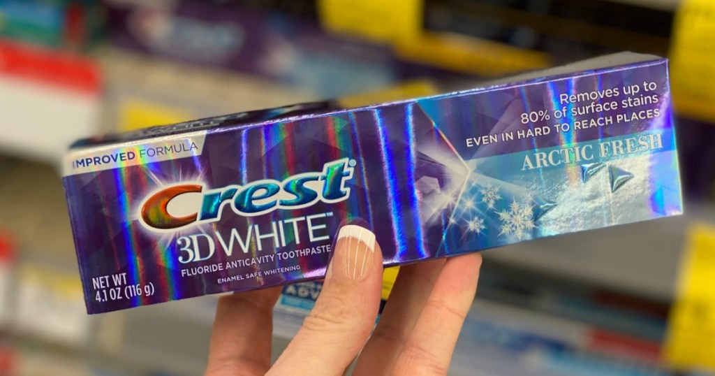 Walgreens toothpaste in hand in package near in-store display