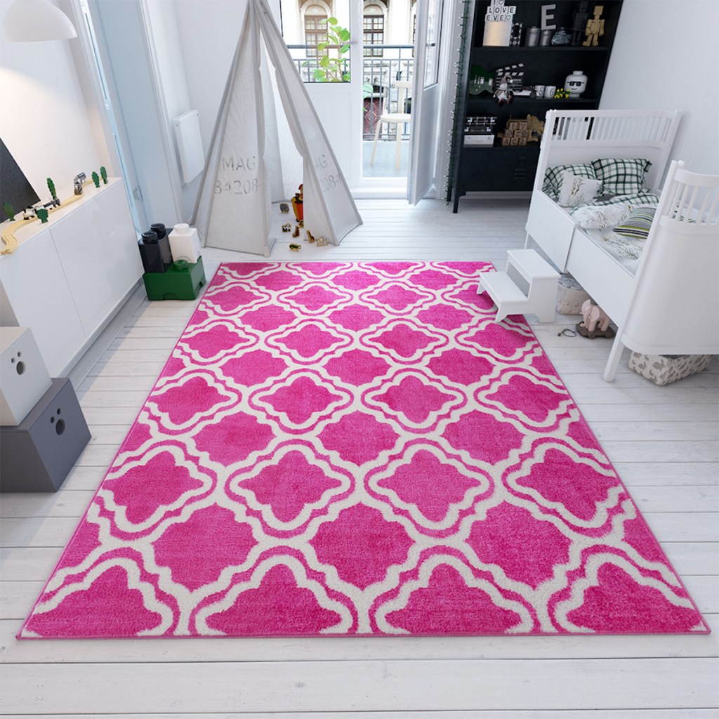 Well Woven Pink Calipso Star Bright area rug in room with white decor