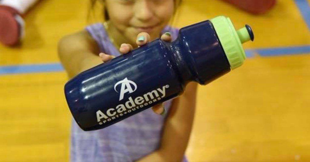 girl holding water bottle with store logo on it