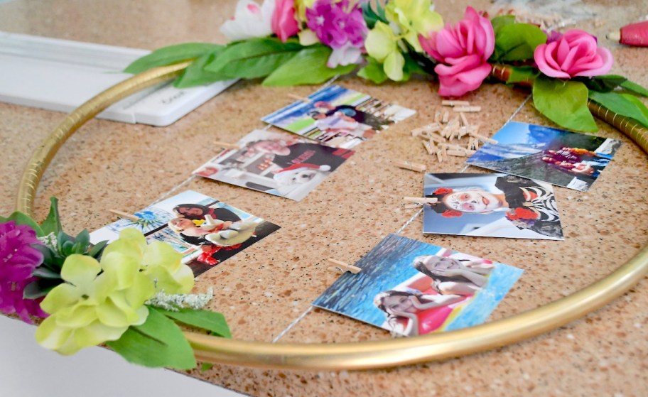 gold hula hoop with colorful florals and pictures in middle