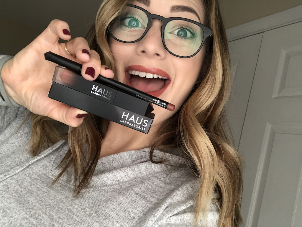 woman holding Haus Laboratories makeup