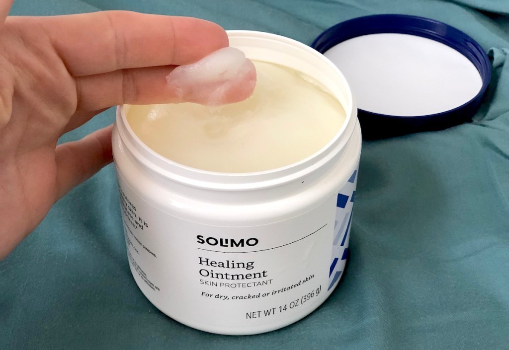 fingers dipped in Solimo Amazon healing ointment