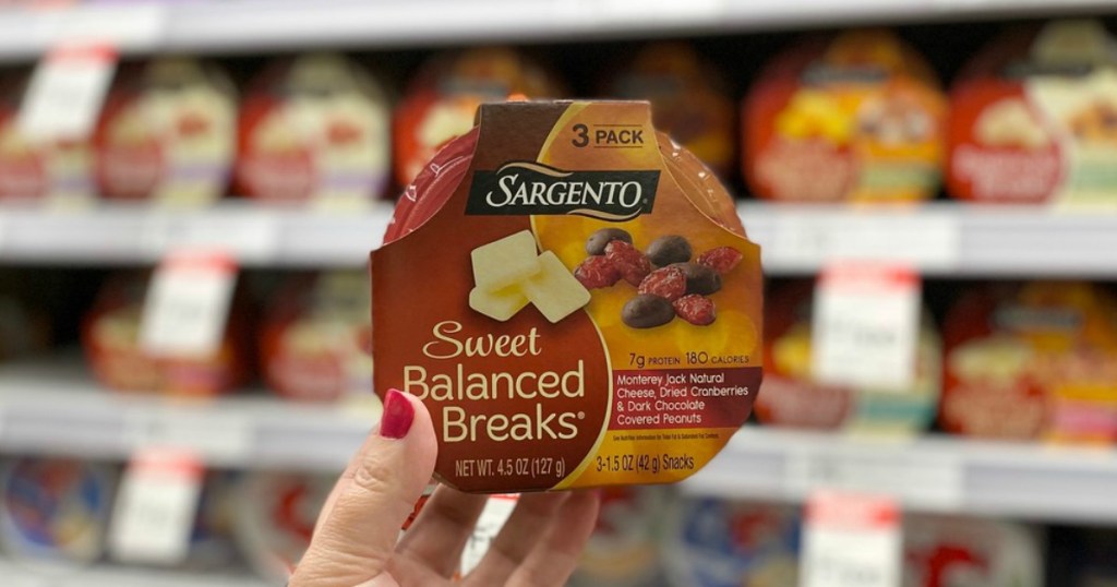 hand holding cheese snacks in a store