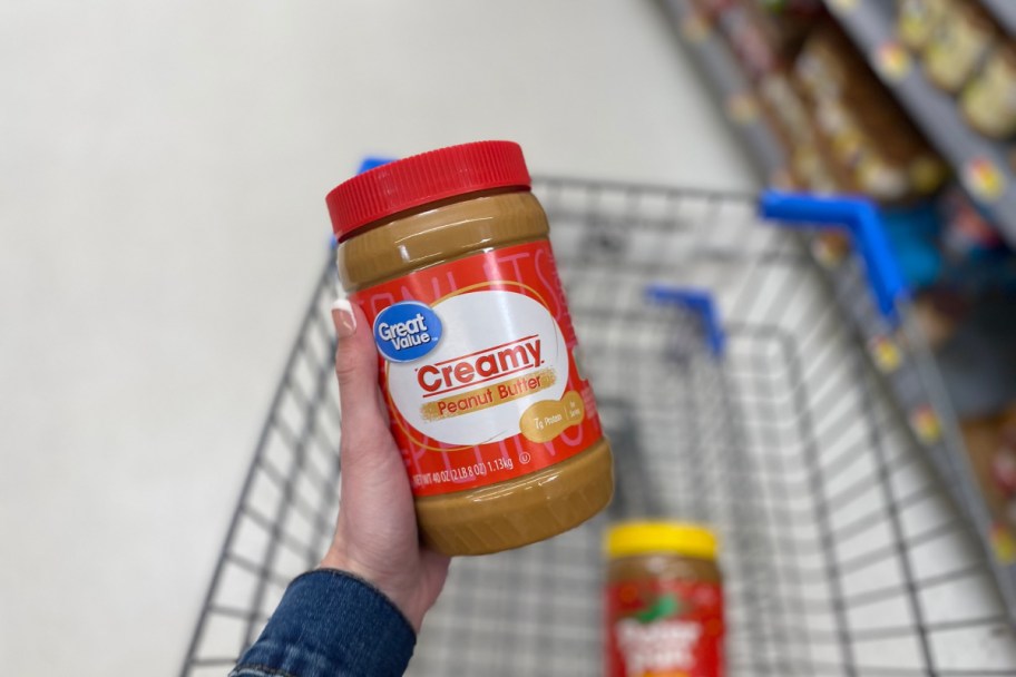 hand holding Great Value peanut butter, one of the off brand items on our store brand vs name brand challenge