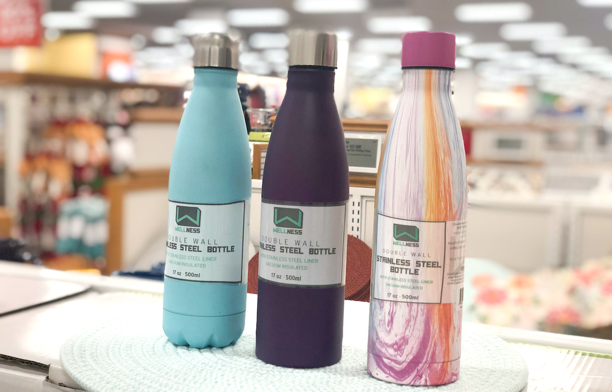 blue purple tie die water bottles sitting on counter in store