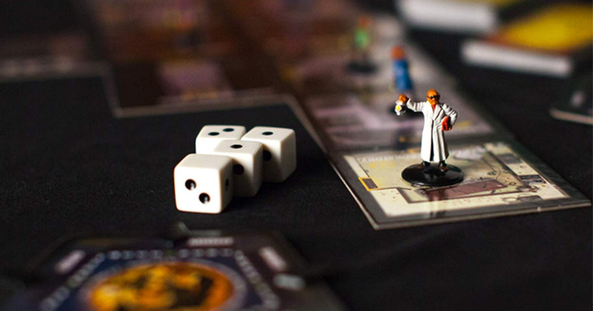 game pieces, dice, and cards on black table