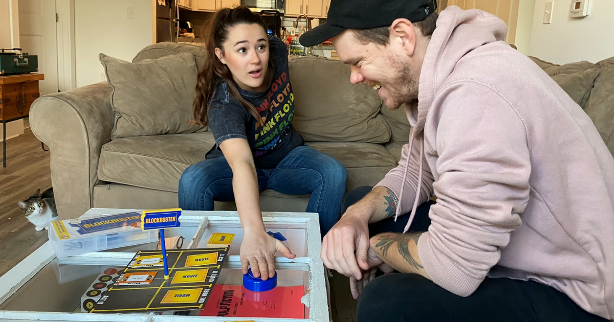 Man and woman playing Blockbuster game in living room