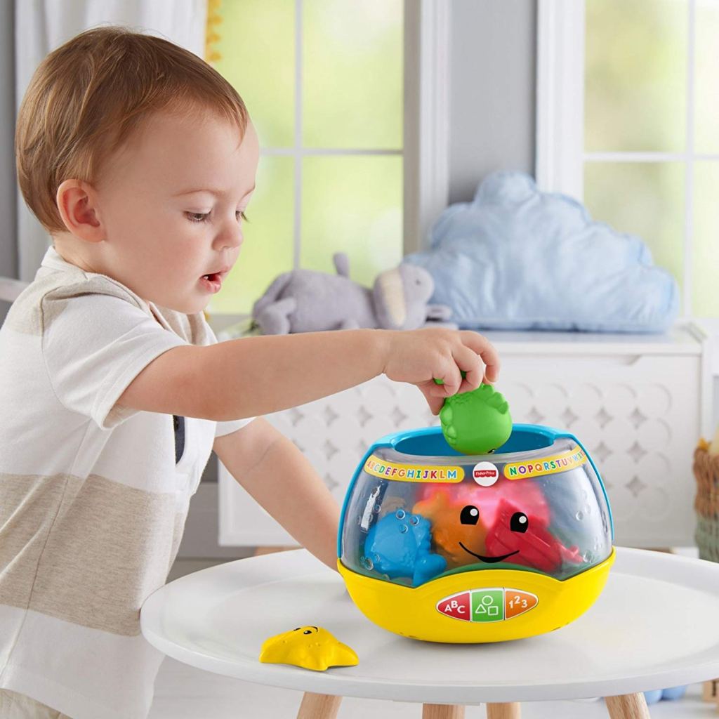 Little boy playing with Fisher Price Fish Bowl