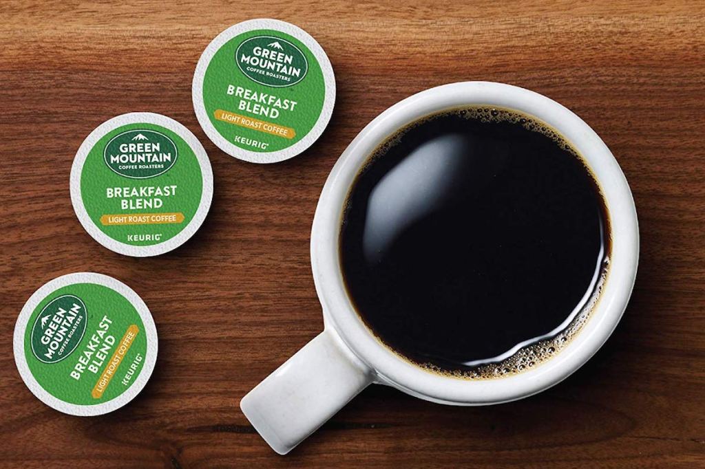 k-cups next to a cup of coffee