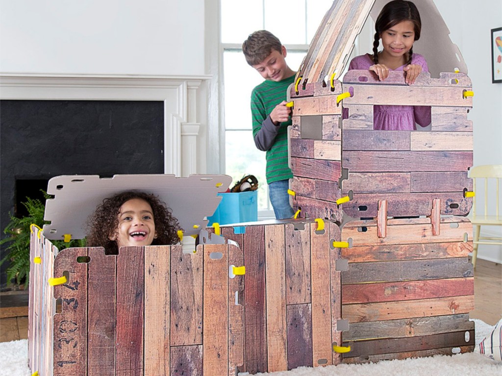 children inside wood play fort inside home