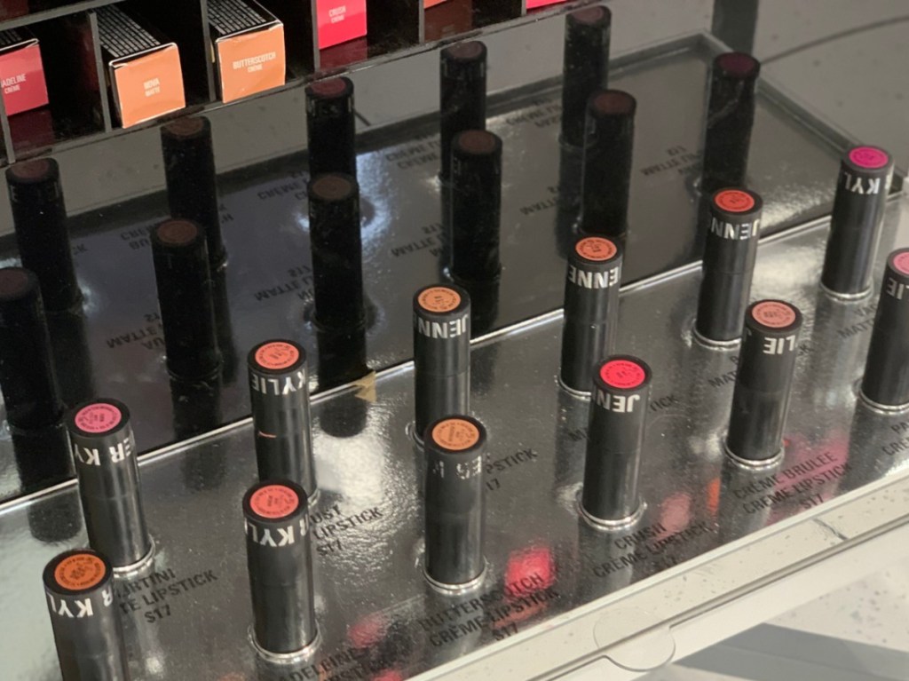 lipsticks standing in display in makeup store