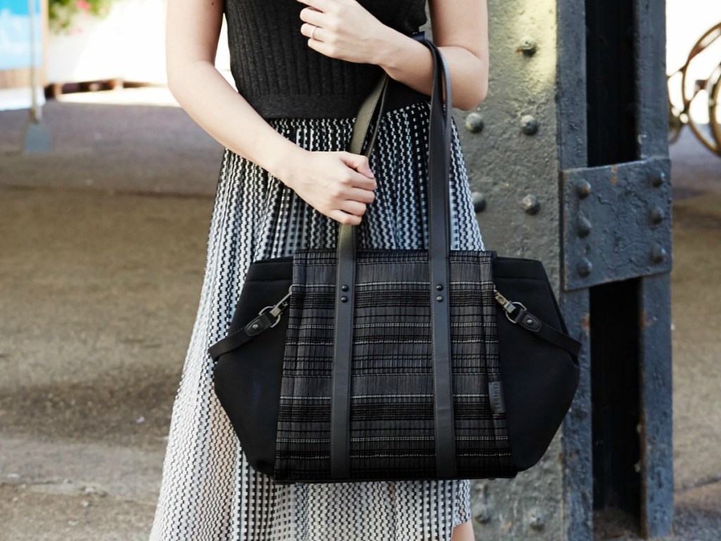 Woman holding a large black fashion diaper bag