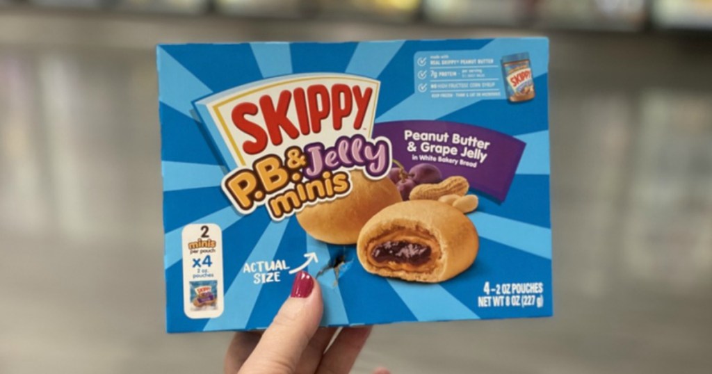 woman's Hand holding up a box of Skippy Minis