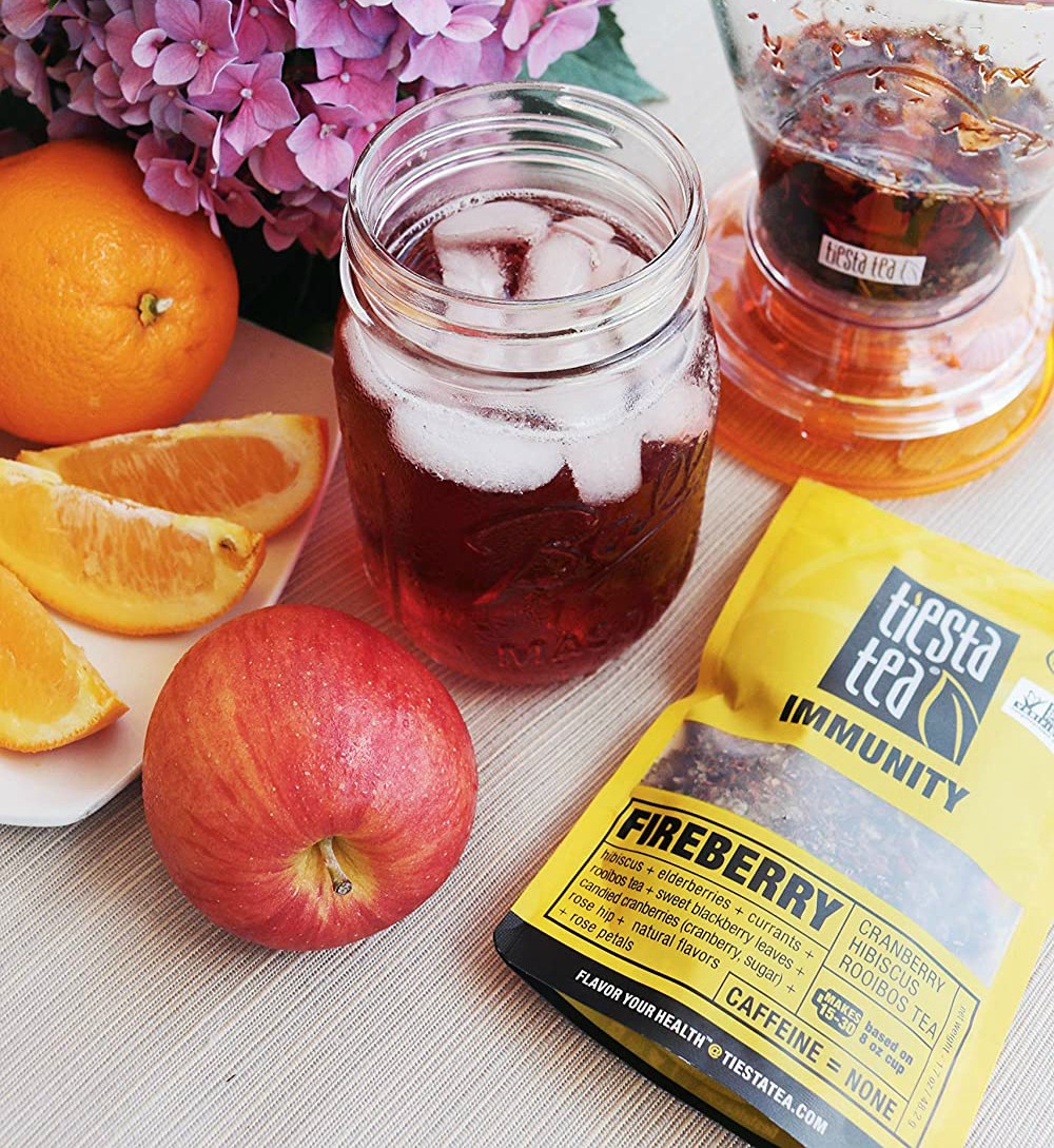 Tiesta fireberry tea in a mason jar next to tea pouch