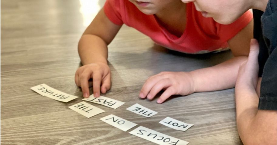 Two kids solving word jumble for obstacle course