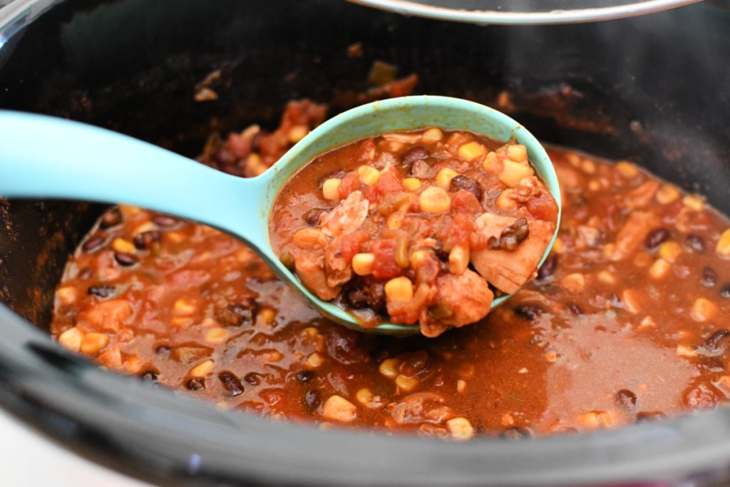 black bean chicken chili on a spoon which is from one of our easy Chicken Crock Pot recipes