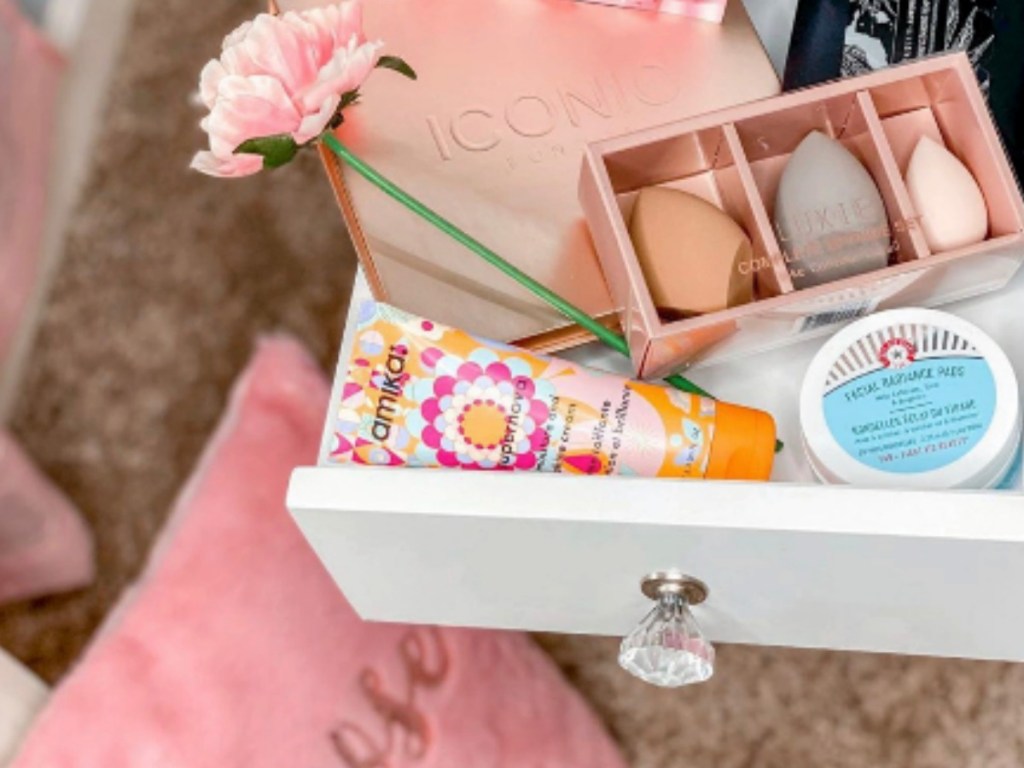 drawer opened up to show make up supplies in pink room