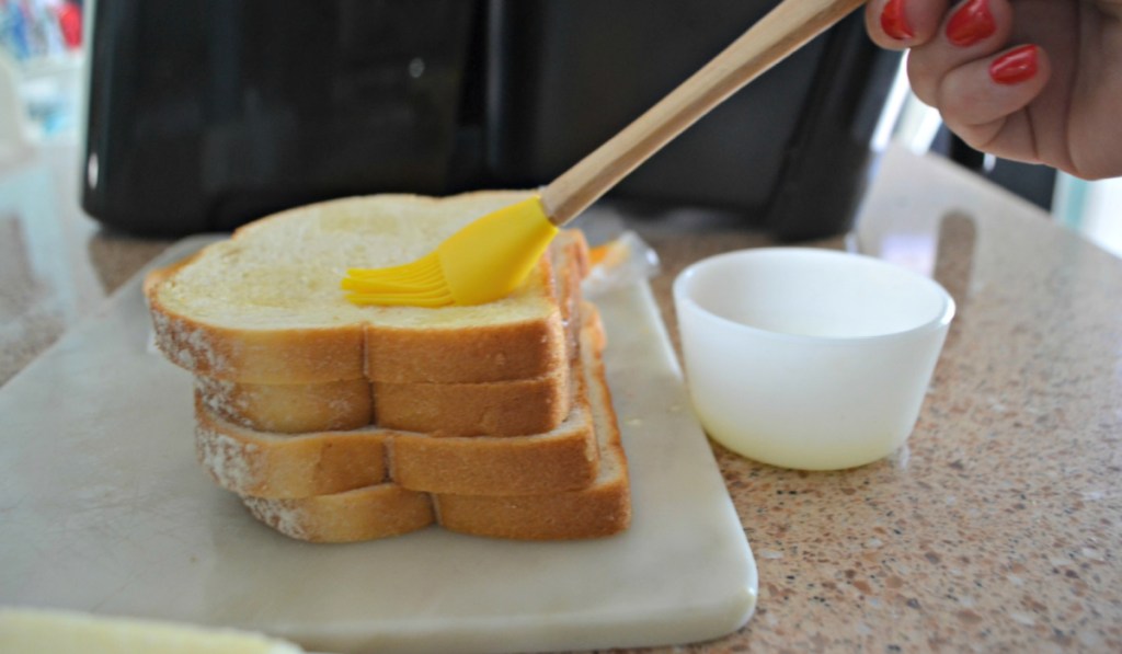 brushing bread with butter