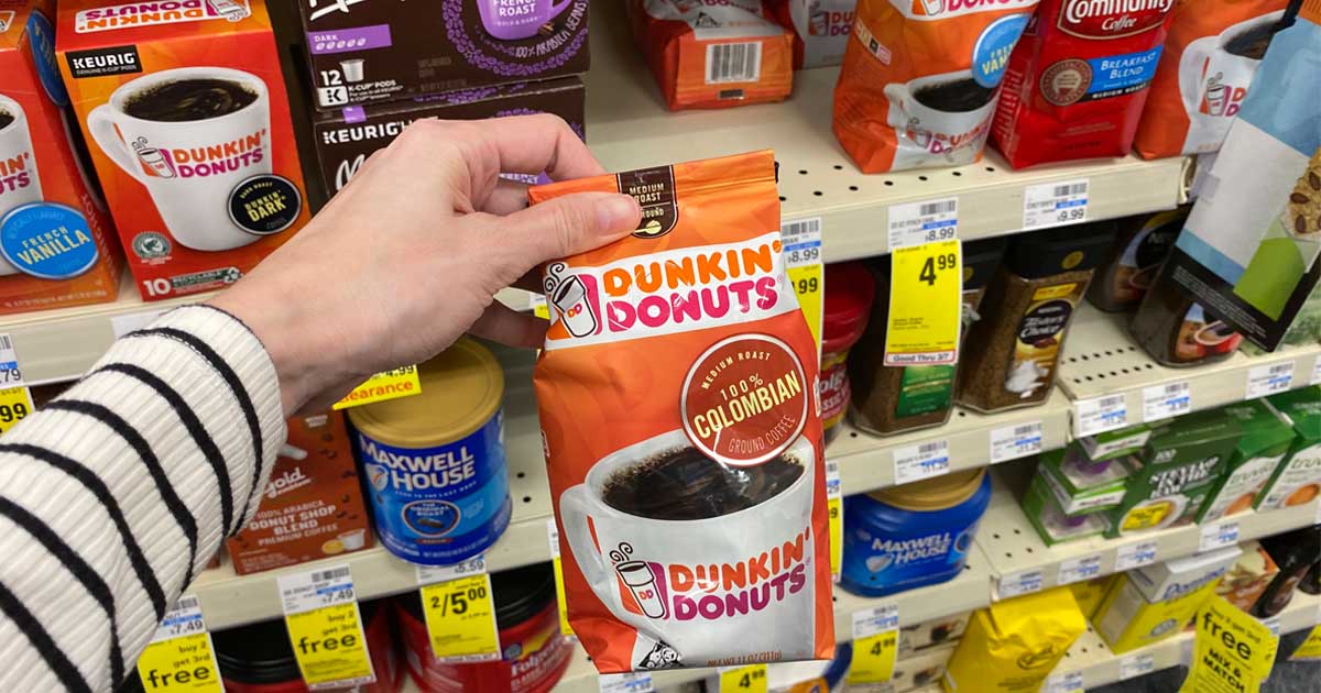 hand holding a bag of Dunkin Donuts coffee