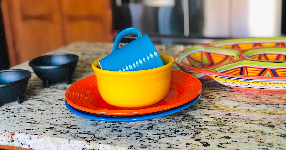 blue orange and yellow dishes on granite countertop