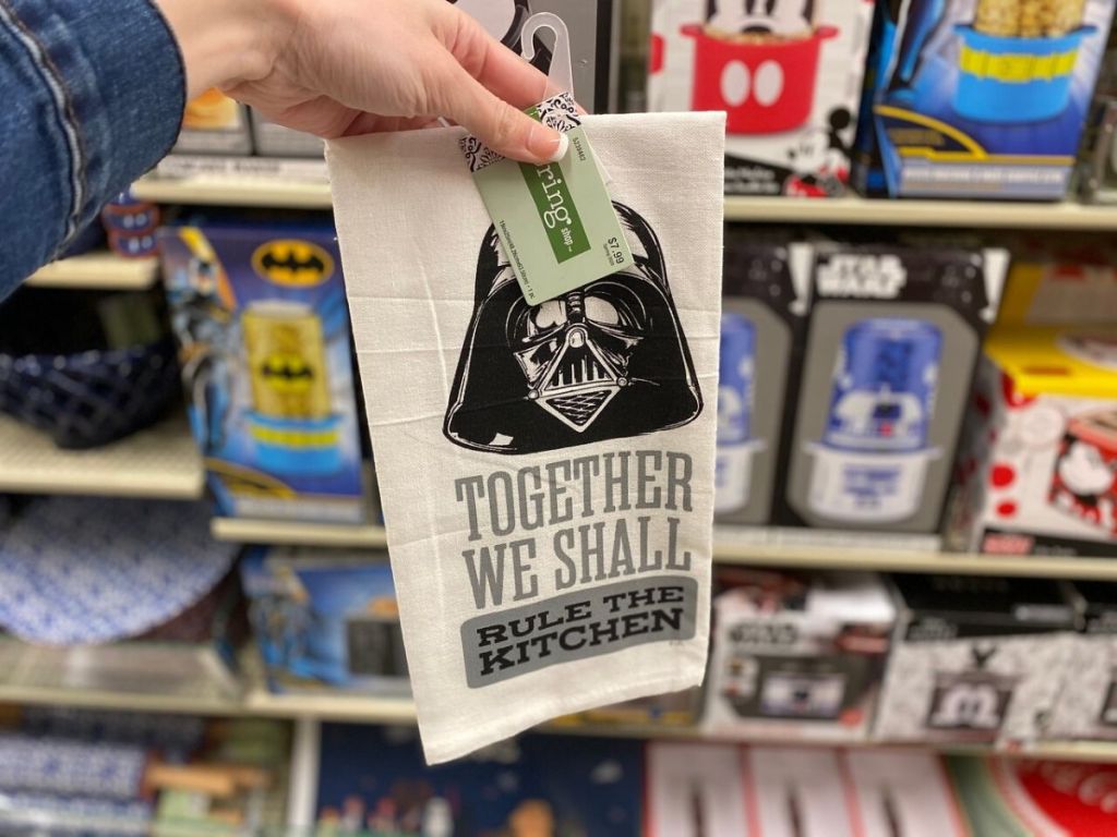 woman's hand holding dish towel in store aisle 