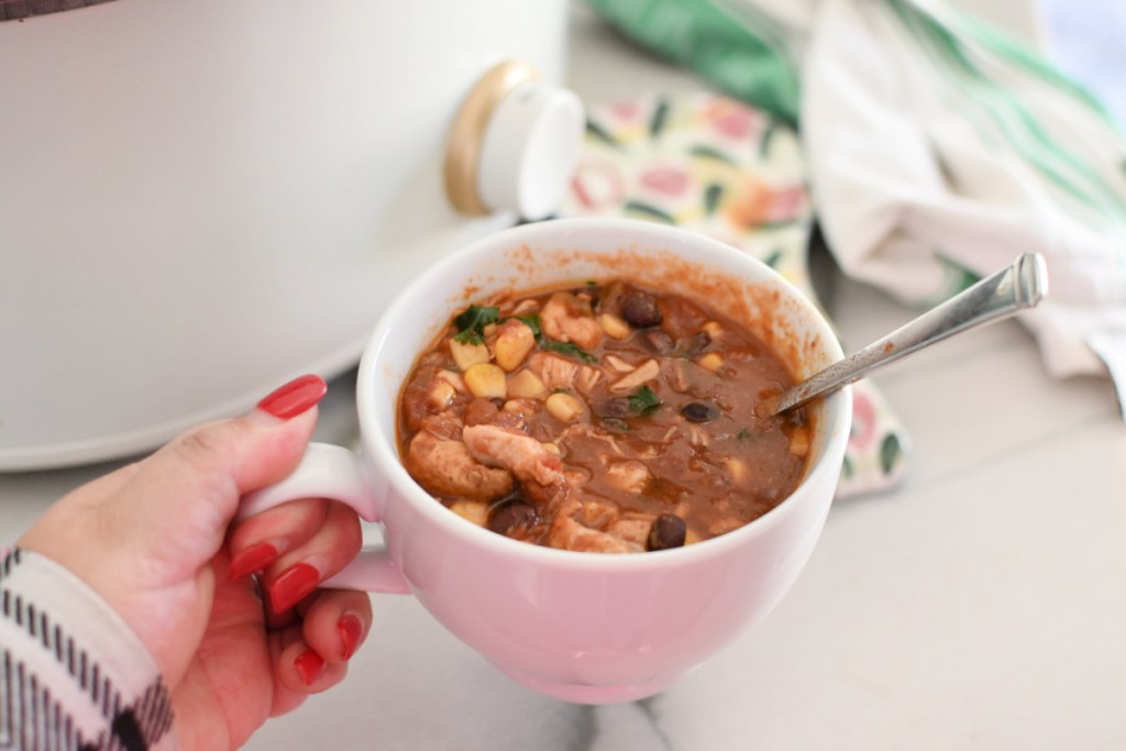 holding a cup of chicken chili